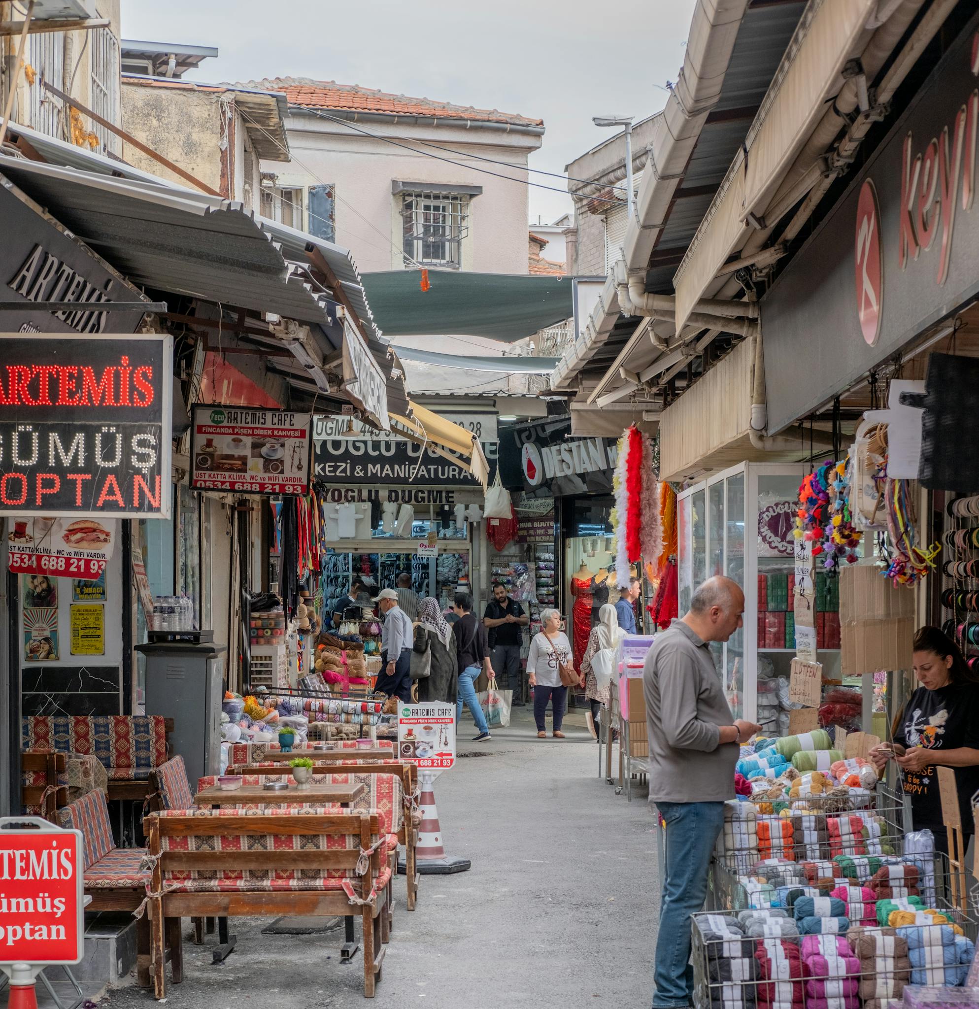 Explore the vibrant market streets of İzmir with local vendors and merchandise.